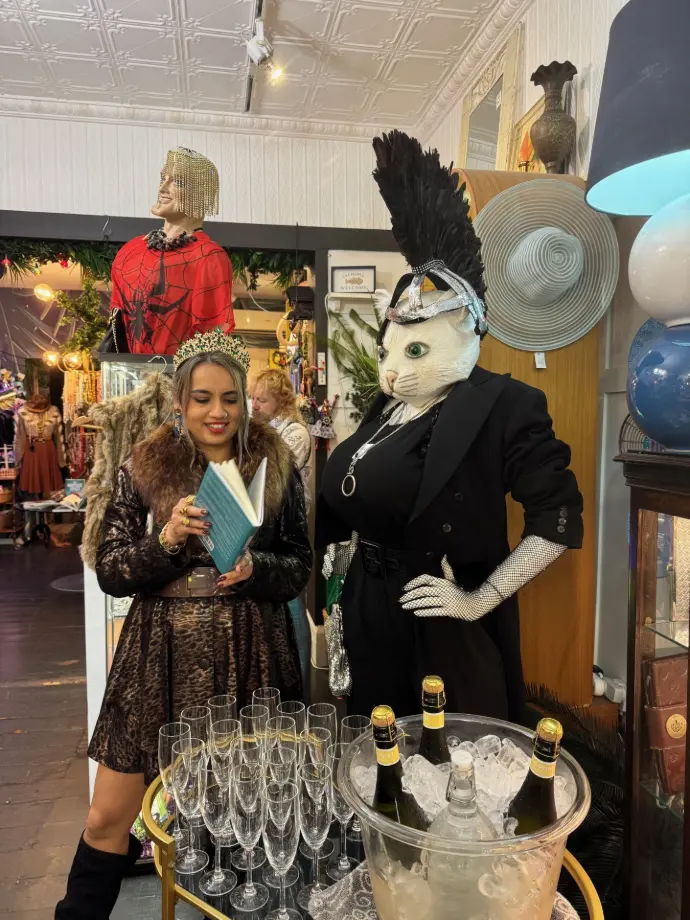 Girl reading to quirky cat in black at That Cat Shop Sydney